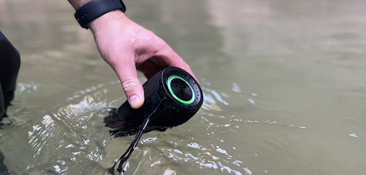 man putting Mega MagnaBOOM in the water